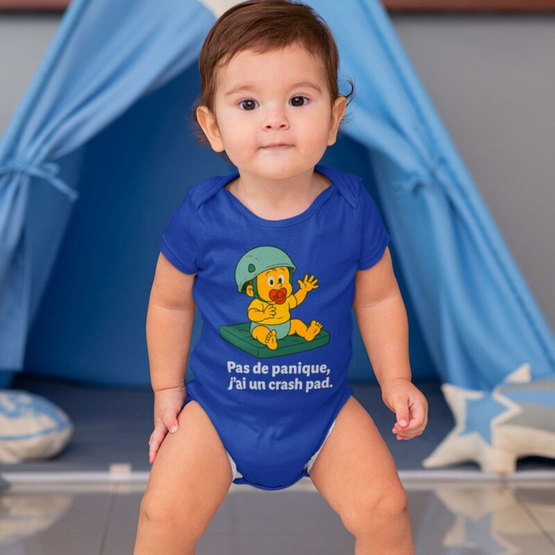 Bébé debout portant le body bleu "Pas de panique, j'ai un crash pad"